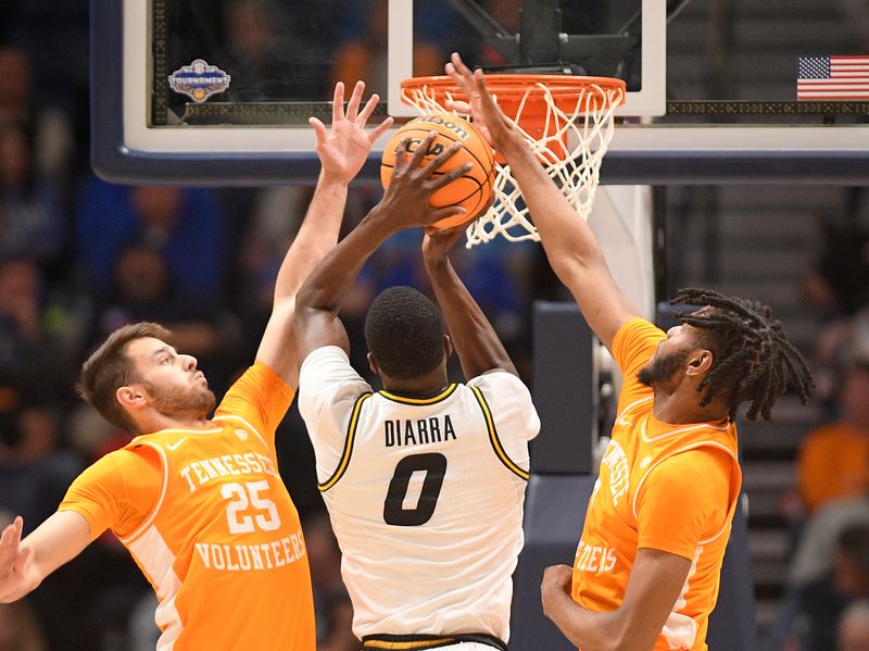 Mar 10, 2023; Nashville, TN, USA;  Tennessee Volunteers guard Santiago Vescovi (25) and Tennessee Volunteers forward Jonas Aidoo (0) block the shot of Missouri Tigers forward Mohamed Diarra (0) during the first half at Bridgestone Arena. Mandatory Credit: Steve Roberts-USA TODAY Sports