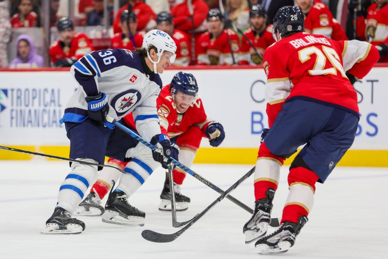 Nov 24, 2023; Sunrise, Florida, USA; Winnipeg Jets center Morgan Barron (36) moves the puck against the Florida Panthers during the first period at Amerant Bank Arena. Mandatory Credit: Sam Navarro-USA TODAY Sports