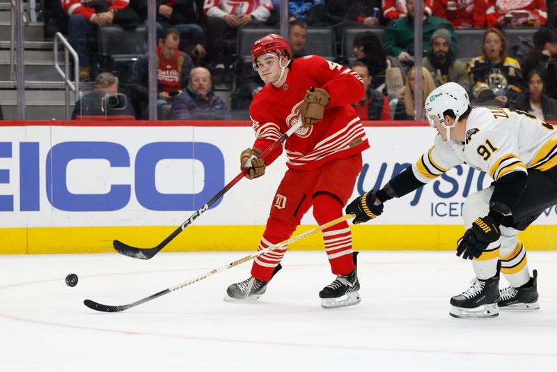 Dec 2, 2025; Detroit, Michigan, USA;  Detroit Red Wings defenseman Axel Sandin-Pellikka (44) takes a shot defended by Boston Bruins defenseman Nikita Zadorov (91) in the second period at Little Caesars Arena. Mandatory Credit: Rick Osentoski-Imagn Images