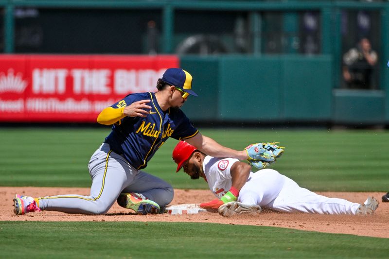 Aug 22, 2024; St. Louis, Missouri, USA;  St. Louis Cardinals center fielder Victor Scott II (11) slides safely past Milwaukee Brewers shortstop Willy Adames (27) for a stolen base during the fifth inning at Busch Stadium. Mandatory Credit: Jeff Curry-USA TODAY Sports