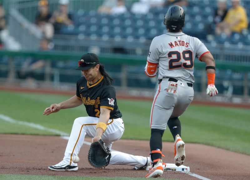 May 22, 2024; Pittsburgh, Pennsylvania, USA;  Pittsburgh Pirates first baseman Connor Joe (2) takes a throw at first base to retire San Francisco Giants center fielder Luis Matos (29) during the first inning at PNC Park. Mandatory Credit: Charles LeClaire-USA TODAY Sports