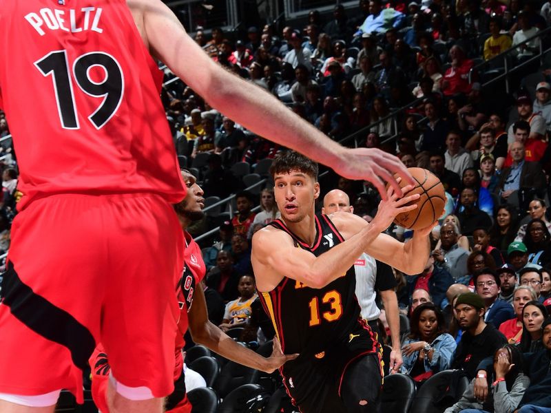 ATLANTA, GA - February 23: Bogdan Bogdanovic #13 of the Atlanta Hawks drives to the basket during the game against the Toronto Raptors on February 23, 2024 at State Farm Arena in Atlanta, Georgia.  NOTE TO USER: User expressly acknowledges and agrees that, by downloading and/or using this Photograph, user is consenting to the terms and conditions of the Getty Images License Agreement. Mandatory Copyright Notice: Copyright 2024 NBAE (Photo by Scott Cunningham/NBAE via Getty Images)