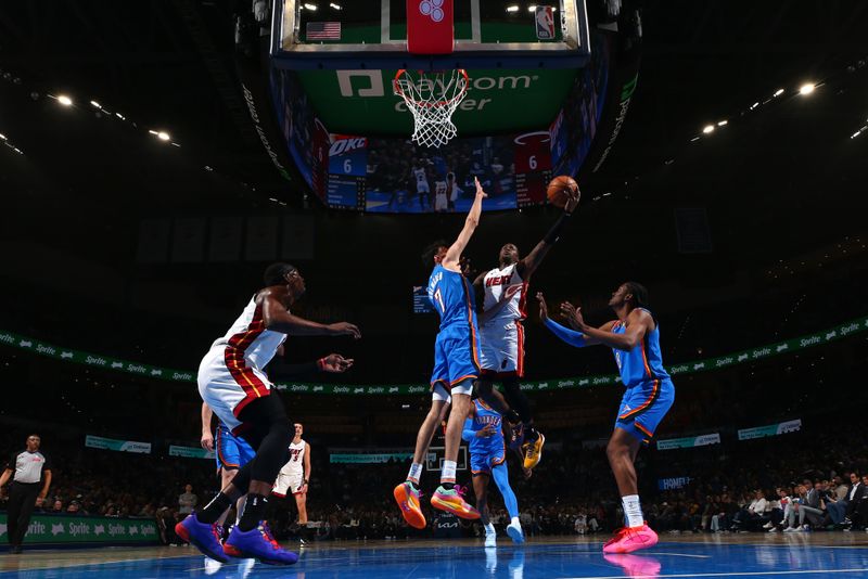 OKLAHOMA CITY, OK - MARCH 8:  Terry Rozier #2 of the Miami Heat drives to the basket during the game as Chet Holmgren #7 of the Oklahoma City Thunder plays defense on March 8, 2024 at Paycom Arena in Oklahoma City, Oklahoma. NOTE TO USER: User expressly acknowledges and agrees that, by downloading and or using this photograph, User is consenting to the terms and conditions of the Getty Images License Agreement. Mandatory Copyright Notice: Copyright 2024 NBAE (Photo by Zach Beeker/NBAE via Getty Images)