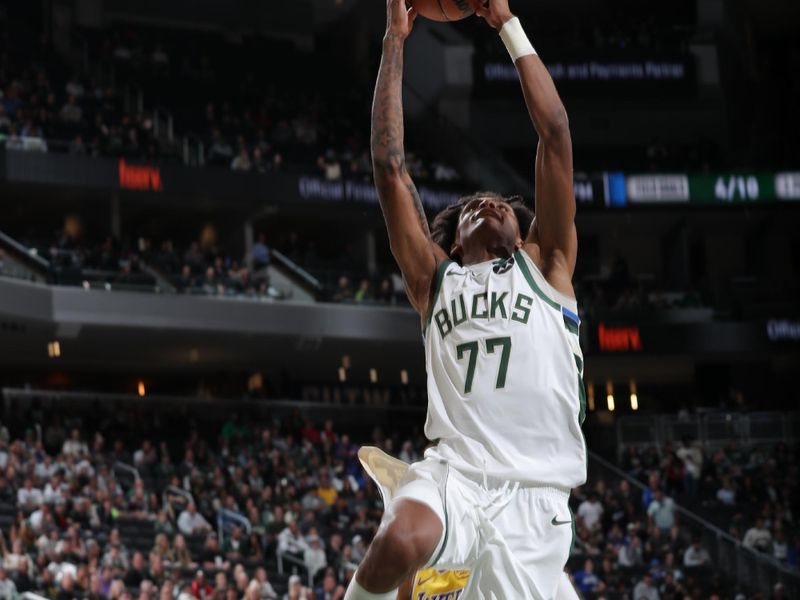 MILWAUKEE, WI - OCTOBER 10: AJ Johnson #77 of the Milwaukee Bucks drives to the basket during the game against the Los Angeles Lakers during a preseason game on October 10, 2024 at Fiserv Forum Center in Milwaukee, Wisconsin. NOTE TO USER: User expressly acknowledges and agrees that, by downloading and or using this Photograph, user is consenting to the terms and conditions of the Getty Images License Agreement. Mandatory Copyright Notice: Copyright 2024 NBAE (Photo by Gary Dineen/NBAE via Getty Images).