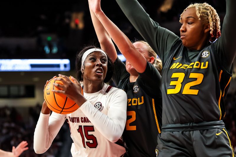 Jan 15, 2023; Columbia, South Carolina, USA; South Carolina Gamecocks forward Laeticia Amihere (15) looks to shoot over Missouri Tigers guard Sara-Rose Smith (2) and Missouri Tigers center Jayla Kelly (32) in the second half at Colonial Life Arena. Mandatory Credit: Jeff Blake-USA TODAY Sports
