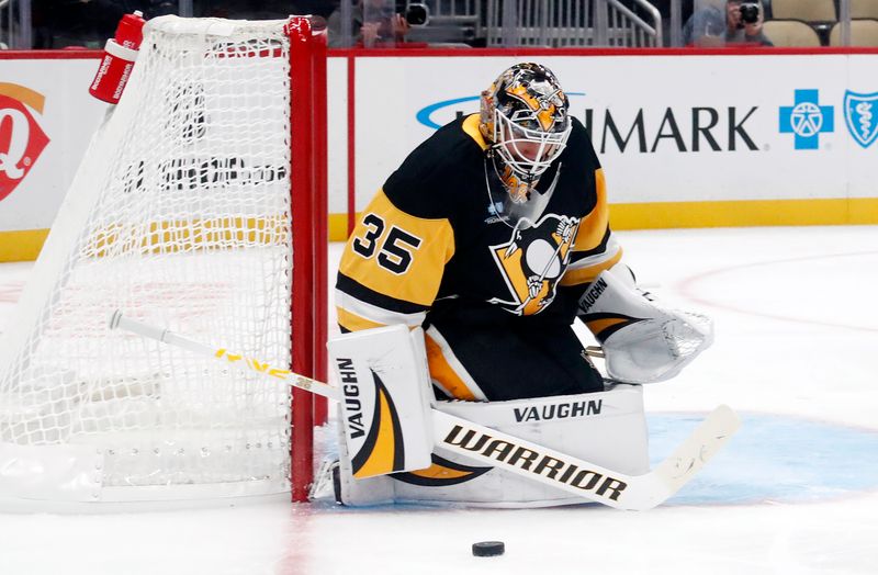 Oct 1, 2024; Pittsburgh, Pennsylvania, USA;  Pittsburgh Penguins goaltender Tristan Jarry (35) makes a save against the Detroit Red Wings during the second period at PPG Paints Arena. Mandatory Credit: Charles LeClaire-Imagn Images