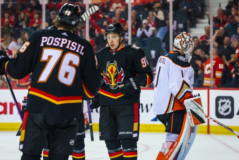 Apr 2, 2024; Calgary, Alberta, CAN; Calgary Flames left wing Andrei Kuzmenko (96) celebrates his goal with teammates against Anaheim Ducks goaltender Lukas Dostal (1) during the third period at Scotiabank Saddledome. Mandatory Credit: Sergei Belski-USA TODAY Sports