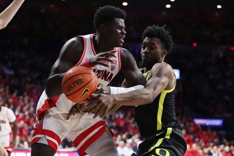 Feb 2, 2023; Tucson, Arizona, USA; Oregon Ducks guard Jermaine Couisnard (5) blocks a pass against Arizona Wildcats center Oumar Ballo (11) in the second half at McKale Center. Mandatory Credit: Zachary BonDurant-USA TODAY Sports