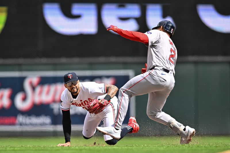 May 4, 2024; Minneapolis, Minnesota, USA; Minnesota Twins shortstop Carlos Correa (4) takes the throw from outfielder Max Kepler (26) and tags out Boston Red Sox first base Dominic Smith (2) attempting to stretch a single into a double during the sixth inning at Target Field. Mandatory Credit: Jeffrey Becker-USA TODAY Sports