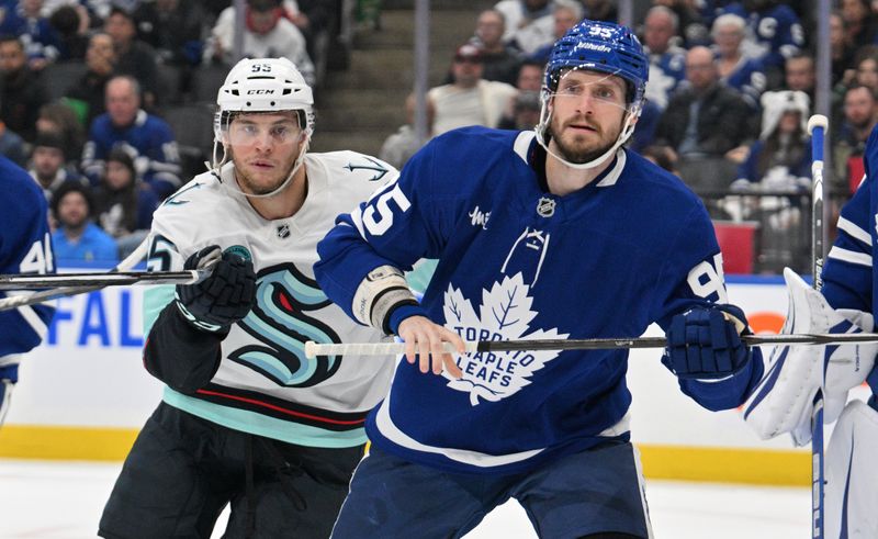 Oct 31, 2024; Toronto, Ontario, CAN;  Toronto Maple Leafs defenseman Oliver Ekman-Larsson (95) tracks the play as he covers Seattle Kraken forward Andre Burakovsky (95) in the second period at Scotiabank Arena. Mandatory Credit: Dan Hamilton-Imagn Images