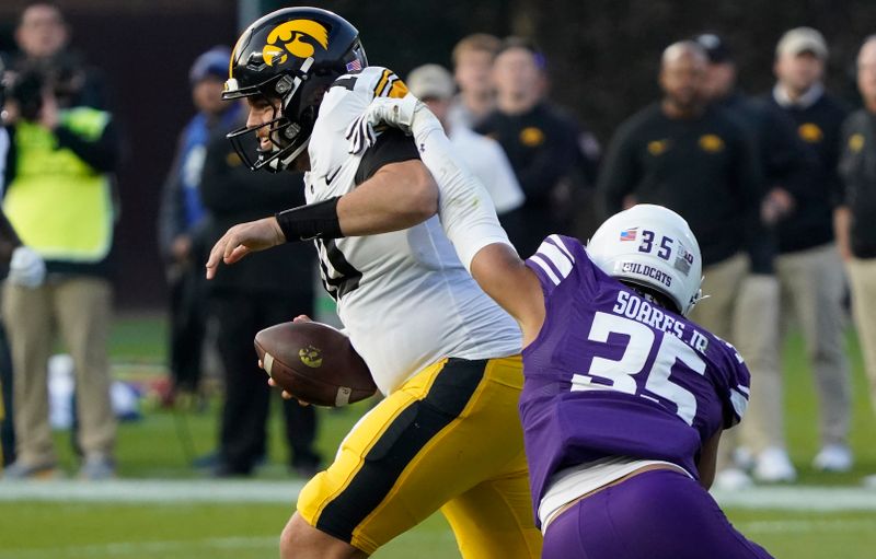 Nov 4, 2023; Chicago, Illinois, USA; Northwestern Wildcats linebacker Kenny Soares Jr. (35) pressures Iowa Hawkeyes quarterback Deacon Hill (10) during the second half at Wrigley Field. Mandatory Credit: David Banks-USA TODAY Sports