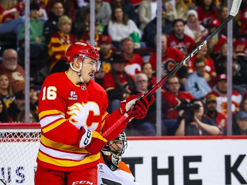 Dec 31, 2025; Calgary, Alberta, CAN; Calgary Flames defenseman Rasmus Andersson (not pictured) scores a goal against Philadelphia Flyers goaltender Samuel Ersson (33) as Calgary Flames center Morgan Frost (16) screens in front during the second period at Scotiabank Saddledome. Mandatory Credit: Sergei Belski-Imagn Images