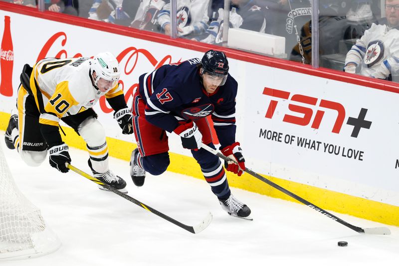 Oct 20, 2024; Winnipeg, Manitoba, CAN; Winnipeg Jets center Adam Lowry (17) is chased down by Pittsburgh Penguins left wing Drew O'Connor (10) in the third period at Canada Life Centre. Mandatory Credit: James Carey Lauder-Imagn Images