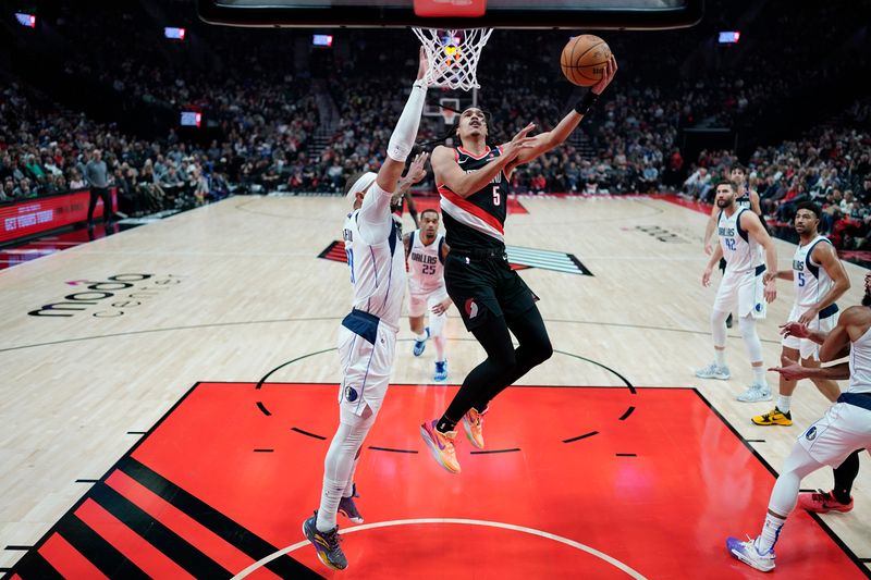 PORTLAND, OREGON - DECEMBER 01: Dalano Banton #5 of the Portland Trail Blazers shoots the ball against Daniel Gafford #21 of the Dallas Mavericks during the first half at Moda Center on December 01, 2024 in Portland, Oregon. NOTE TO USER: User expressly acknowledges and agrees that, by downloading and or using this photograph, User is consenting to the terms and conditions of the Getty Images License Agreement. (Photo by Soobum Im/Getty Images)