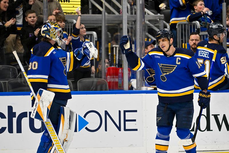 Jan 9, 2024; St. Louis, Missouri, USA;  St. Louis Blues center Brayden Schenn (10) celebrates with goaltender Joel Hofer (30) after scoring against the Florida Panthers during the first period at Enterprise Center. Mandatory Credit: Jeff Curry-USA TODAY Sports