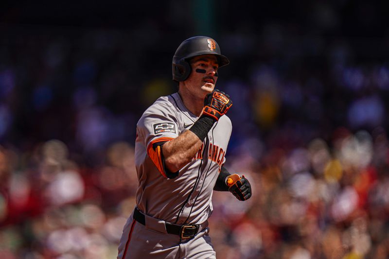 May 2, 2024; Boston, Massachusetts, USA; San Francisco Giants right fielder Mike Yastrzemski (5) hits a home run against the Boston Red Sox in the third inning at Fenway Park. Mandatory Credit: David Butler II-USA TODAY Sports