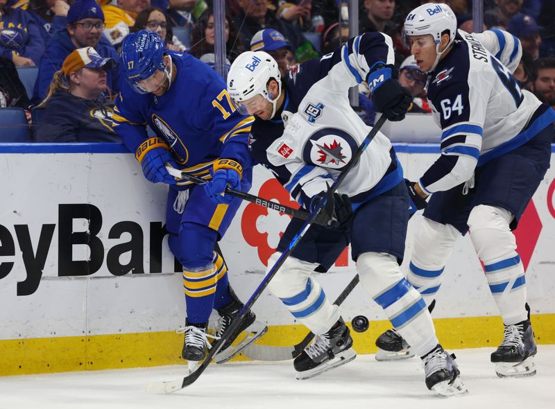 Dec 1, 2025; Buffalo, New York, USA;  Buffalo Sabres left wing Jason Zucker (17) and Winnipeg Jets defenseman Colin Miller (6) try to control the puck behind the net during the second period at KeyBank Center. Mandatory Credit: Timothy T. Ludwig-Imagn Images