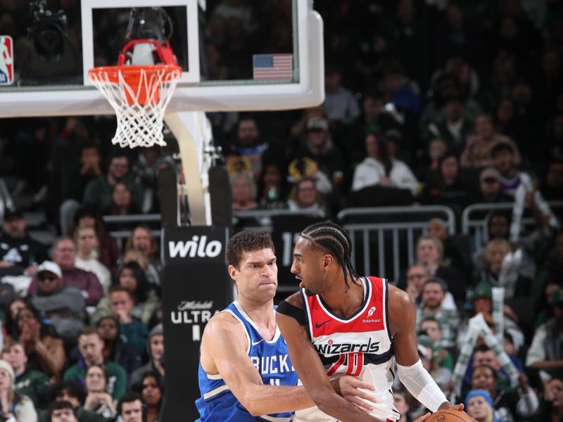 MILWAUKEE, WI - NOVEMBER 30: Alexandre Sarr #20 of the Washington Wizards handles the ball during the game against the Milwaukee Bucks on November 30, 2024 at Fiserv Forum Center in Milwaukee, Wisconsin. NOTE TO USER: User expressly acknowledges and agrees that, by downloading and or using this Photograph, user is consenting to the terms and conditions of the Getty Images License Agreement. Mandatory Copyright Notice: Copyright 2024 NBAE (Photo by Gary Dineen/NBAE via Getty Images).