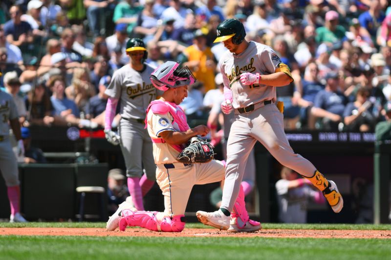 May 12, 2024; Seattle, Washington, USA; Oakland Athletics shortstop Max Schuemann (12) crosses home plate after hitting a home run against the Seattle Mariners during the fifth inning at T-Mobile Park. Mandatory Credit: Steven Bisig-USA TODAY Sports