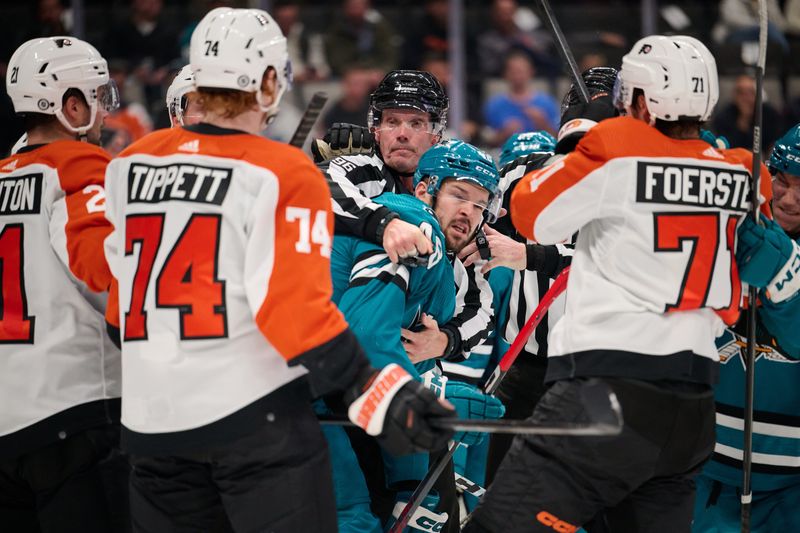 Nov 7, 2023; San Jose, California, USA; Linesman David Brisebois (96) restrains San Jose Sharks center Tomas Hertl (48) from Philadelphia Flyers forwards Owen Tippett (74) and Tyson Foerster (71) during the second period at SAP Center at San Jose. Mandatory Credit: Robert Edwards-USA TODAY Sports