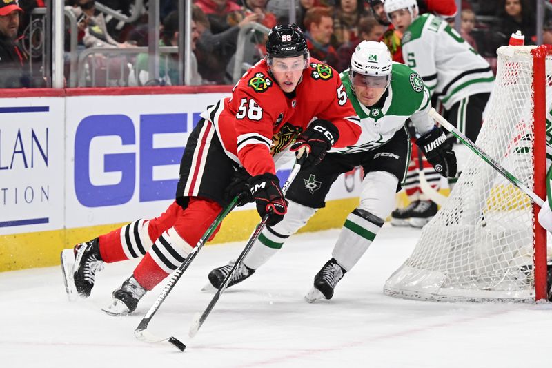 Jan 13, 2024; Chicago, Illinois, USA;  Chicago Blackhawks forward MacKenzie Entwistle (58) controls the puck while being pursued by Dallas Stars forward Roope Hintz (24) in the third period at United Center. Mandatory Credit: Jamie Sabau-USA TODAY Sports