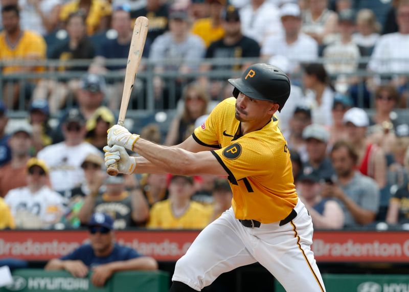 Jun 22, 2024; Pittsburgh, Pennsylvania, USA;  Pittsburgh Pirates left fielder Bryan Reynolds (10) hits an RBI single against the Tampa Bay Rays during the third inning at PNC Park. Mandatory Credit: Charles LeClaire-USA TODAY Sports