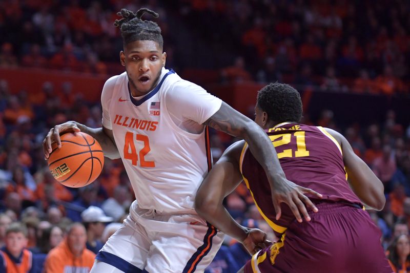 Feb 28, 2024; Champaign, Illinois, USA; Illinois Fighting Illini forward Dain Dainja (42) drives the ball past Minnesota Golden Gophers forward Pharrel Payne (21) during the first half at State Farm Center. Mandatory Credit: Ron Johnson-USA TODAY Sports