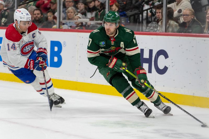 Dec 21, 2023; Saint Paul, Minnesota, USA; Minnesota Wild left wing Marcus Foligno (17) is checked by Montreal Canadiens center Nick Suzuki (14) in the third period at Xcel Energy Center. Mandatory Credit: Matt Blewett-USA TODAY Sports