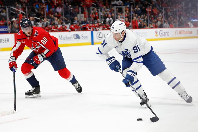 Nov 13, 2024; Washington, District of Columbia, USA; Toronto Maple Leafs center John Tavares (91) skates with the puck as Washington Capitals left wing Pierre-Luc Dubois (80) chases in overtime at Capital One Arena. Mandatory Credit: Geoff Burke-Imagn Images