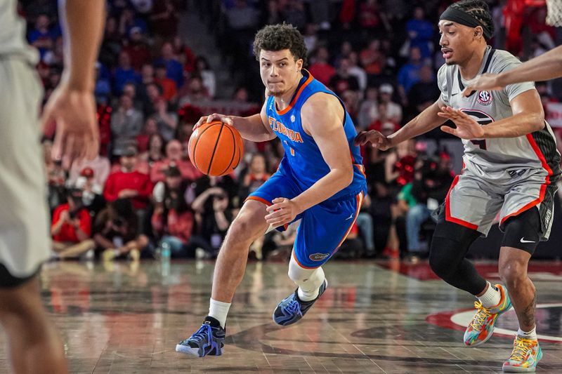 Feb 25, 2025; Athens, Georgia, USA; Florida Gators guard Walter Clayton Jr. (1) dribbles past Georgia Bulldogs guard Tyrin Lawrence (7) during the second half at Stegeman Coliseum. Mandatory Credit: Dale Zanine-Imagn Images