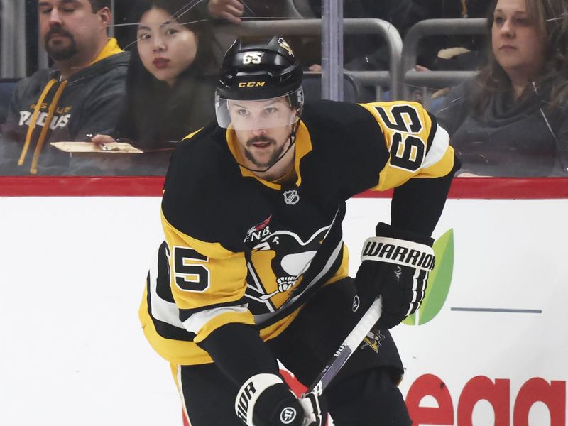 Feb 2, 2026; Pittsburgh, Pennsylvania, USA;  Pittsburgh Penguins defenseman Erik Karlsson (65) skates with the puck against the Ottawa Senators during the first period at PPG Paints Arena. Mandatory Credit: Charles LeClaire-Imagn Images