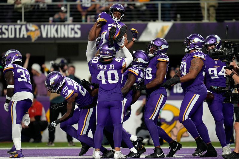 Minnesota Vikings defenders celebrate after recovering a fumble by San Francisco 49ers running back Christian McCaffrey during the first half of an NFL football game, Monday, Oct. 23, 2023, in Minneapolis. (AP Photo/Abbie Parr)