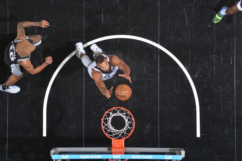 SAN ANTONIO, TX - NOVEMBER 2: Rudy Gobert #27 of the Minnesota Timberwolves goes up for the rebound during the game against the San Antonio Spurs on November 2, 2024 at the Frost Bank Center in San Antonio, Texas. NOTE TO USER: User expressly acknowledges and agrees that, by downloading and or using this photograph, user is consenting to the terms and conditions of the Getty Images License Agreement. Mandatory Copyright Notice: Copyright 2024 NBAE (Photos by Michael Gonzales/NBAE via Getty Images)