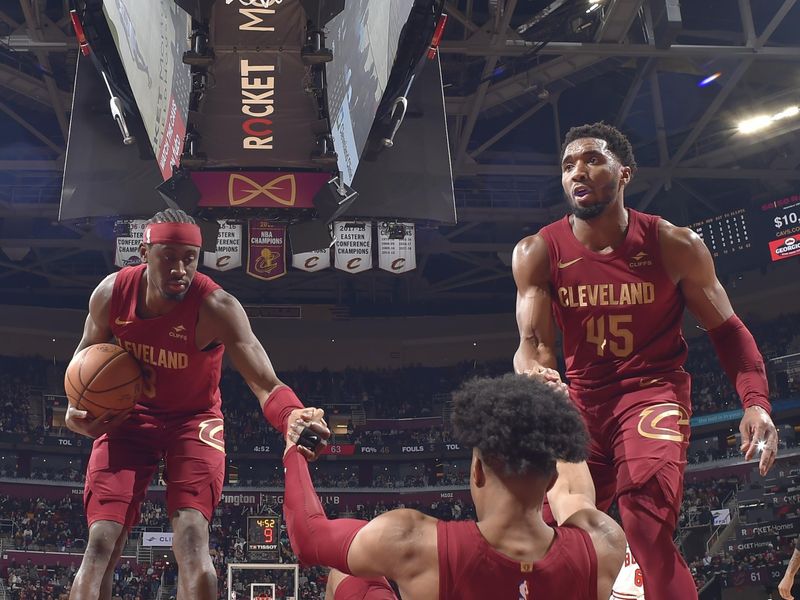 CLEVELAND, OH - FEBRUARY 14: Isaac Okoro #35 of the Cleveland Cavaliers is helped up by Caris LeVert #3 and Donovan Mitchell #45 during the game against the Chicago Bulls on February 14, 2024 at Rocket Mortgage FieldHouse in Cleveland, Ohio. NOTE TO USER: User expressly acknowledges and agrees that, by downloading and/or using this Photograph, user is consenting to the terms and conditions of the Getty Images License Agreement. Mandatory Copyright Notice: Copyright 2024 NBAE (Photo by David Liam Kyle/NBAE via Getty Images)