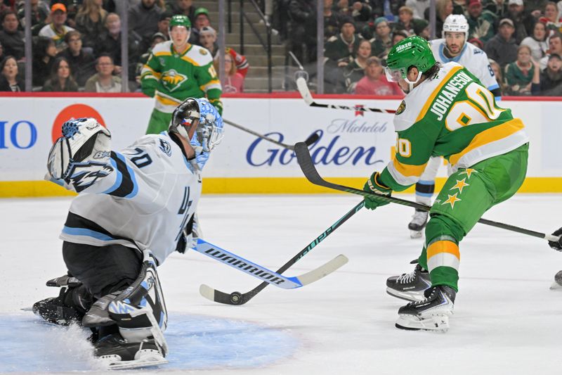 Oct 25, 2025; Saint Paul, Minnesota, USA;  Utah Mammoth goalie Karel Vejmelka (70) makes a save on Minnesota Wild forward Marcus Johansson (90) during the second period at Grand Casino Arena. Mandatory Credit: Nick Wosika-Imagn Images