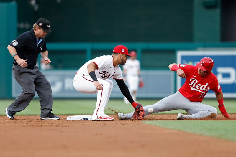 Jul 19, 2024; Washington, District of Columbia, USA; Cincinnati Reds outfielder Stuart Fairchild (17) steals second base as Washington Nationals second base Luis García Jr. (2) loses the ball on the attempted tag during the third inning at Nationals Park. Mandatory Credit: Geoff Burke-USA TODAY Sports