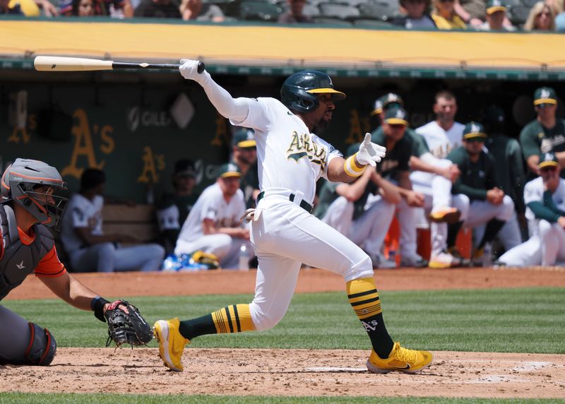 Jul 23, 2023; Oakland, California, USA; Oakland Athletics left fielder Tony Kemp (5) hits a single against the Houston Astros during the third inning at Oakland-Alameda County Coliseum. Mandatory Credit: Kelley L Cox-USA TODAY Sports