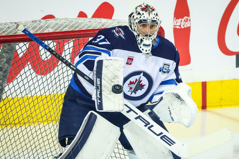 Nov 15, 2025; Calgary, Alberta, CAN; Winnipeg Jets goaltender Connor Hellebuyck (37) guards his net during the warmup period against the Calgary Flames at Scotiabank Saddledome. Mandatory Credit: Sergei Belski-Imagn Images