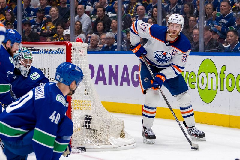 May 10, 2024; Vancouver, British Columbia, CAN; Edmonton Oilers forward Connor McDavid (97) looks to pass against the Vancouver Canucks during the second period in game two of the second round of the 2024 Stanley Cup Playoffs at Rogers Arena. Mandatory Credit: Bob Frid-USA TODAY Sports