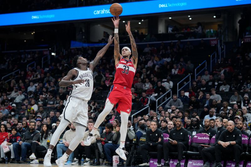 WASHINGTON, DC - DECEMBER 29: Kyle Kuzma #33 of the Washington Wizards shoots against Dorian Finney-Smith #28 of the Brooklyn Nets during the first half at Capital One Arena on December 29, 2023 in Washington, DC. NOTE TO USER: User expressly acknowledges and agrees that, by downloading and or using this photograph, User is consenting to the terms and conditions of the Getty Images License Agreement. (Photo by Jess Rapfogel/Getty Images)