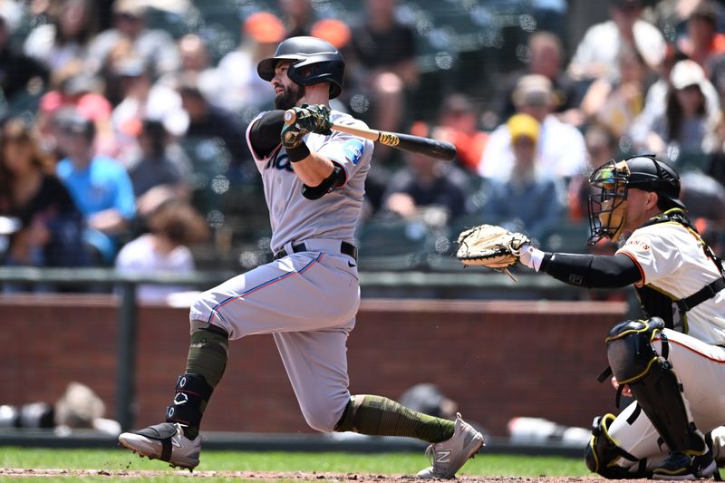 May 21, 2023; San Francisco, California, USA; Miami Marlins infielder Jon Berti (5) hits a single against the San Francisco Giants during the third inning at Oracle Park. Mandatory Credit: Robert Edwards-USA TODAY Sports