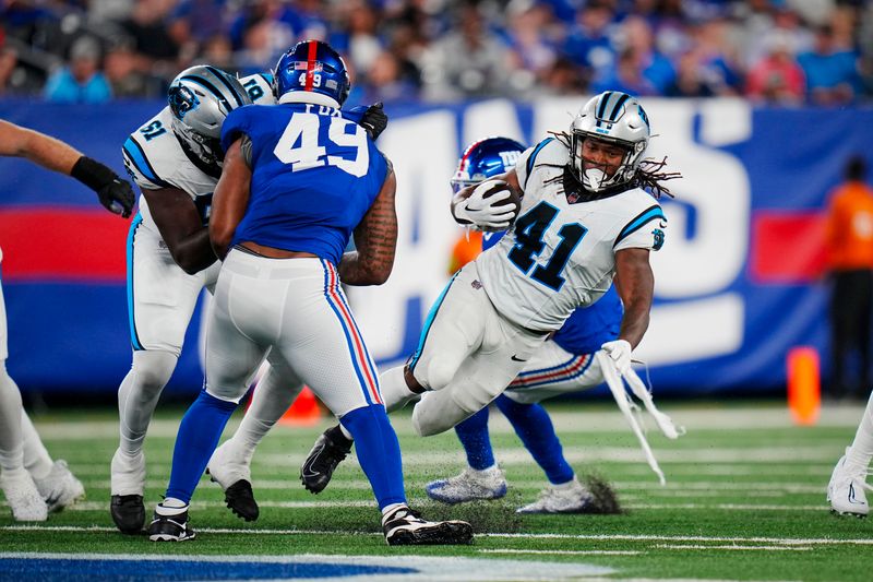 Carolina Panthers running back Spencer Brown (41) runs the balls past New York Giants linebacker Tomon Fox (49) during an NFL pre-season football game on Friday, Aug. 18, 2023, in East Rutherford, N.J. (AP Photo/Rusty Jones)