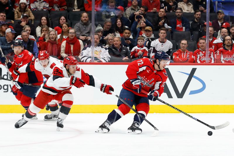 Dec 11, 2025; Washington, District of Columbia, USA; Washington Capitals left wing Anthony Beauvillier (72) skates with the puck as Carolina Hurricanes center Logan Stankoven (22) defends during the first period at Capital One Arena. Mandatory Credit: Geoff Burke-Imagn Images