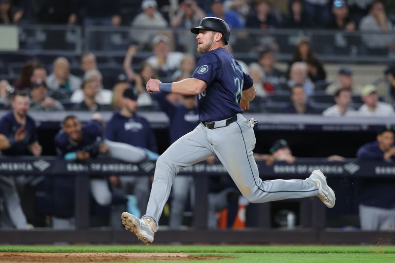 May 20, 2024; Bronx, New York, USA; Seattle Mariners left fielder Luke Raley (20) scores on a sacrifice fly by right fielder Dominic Canzone (not pictured) during the ninth inning against the New York Yankees at Yankee Stadium. Mandatory Credit: Brad Penner-USA TODAY Sports