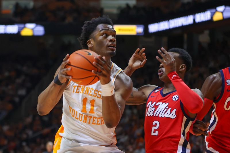 Jan 6, 2024; Knoxville, Tennessee, USA; Tennessee Volunteers forward Tobe Awaka (11) goes to the basket against Mississippi Rebels guard TJ Caldwell (2) during the first half at Thompson-Boling Arena at Food City Center. Mandatory Credit: Randy Sartin-USA TODAY Sports