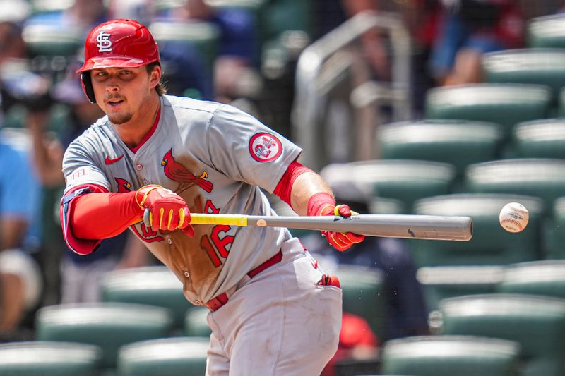 Jul 21, 2024; Cumberland, Georgia, USA; St. Louis Cardinals second baseman Nolan Gorman (16) tries to get down a bunt against the Atlanta Braves during the seventh inning at Truist Park. Mandatory Credit: Dale Zanine-USA TODAY Sports