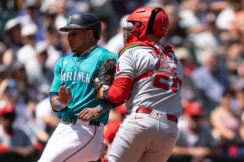 Jul 24, 2024; Seattle, Washington, USA;  Los Angeles Angels catcher Matt Thaiss (21) tags out Seattle Mariners second baseman Jorge Polanco (7) at home plate during the fourth inning at T-Mobile Park. Mandatory Credit: Stephen Brashear-USA TODAY Sports