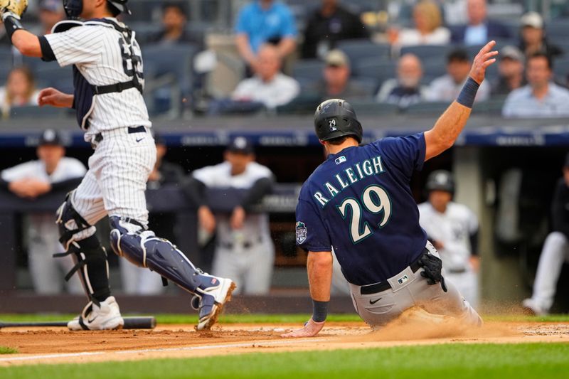 Jun 22, 2023; Bronx, New York, USA; Seattle Mariners catcher Cal Raleigh (29) scores a run on Seattle Mariners designated hitter Mike Ford (not pictured) sacrifice fly ball against the New York Yankees during the first inning at Yankee Stadium. Mandatory Credit: Gregory Fisher-USA TODAY Sports