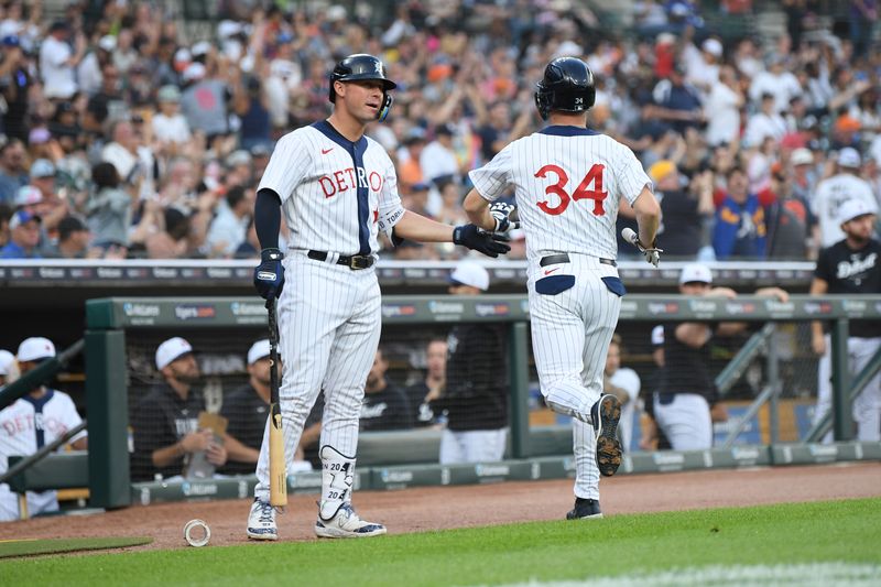 Jul 22, 2023; Detroit, Michigan, USA; Detroit Tigers catcher Jake Rogers (34) (left) celebrates with first baseman Spencer Torkelson (20)) after scoring the second run on a two-run single from third baseman Zack Short (59) (not pictured) against the San Diego Padres in the second inning at Comerica Park. Mandatory Credit: Lon Horwedel-USA TODAY Sports