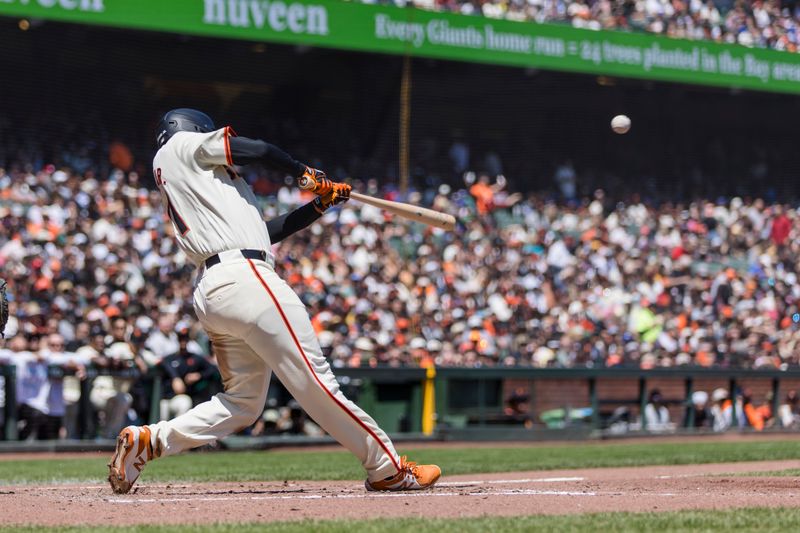 Apr 28, 2024; San Francisco, California, USA;  San Francisco Giants first baseman LaMonte Wade Jr. (31) hits an RBI single against the Pittsburgh Pirates during the third inning at Oracle Park. Mandatory Credit: John Hefti-USA TODAY Sports